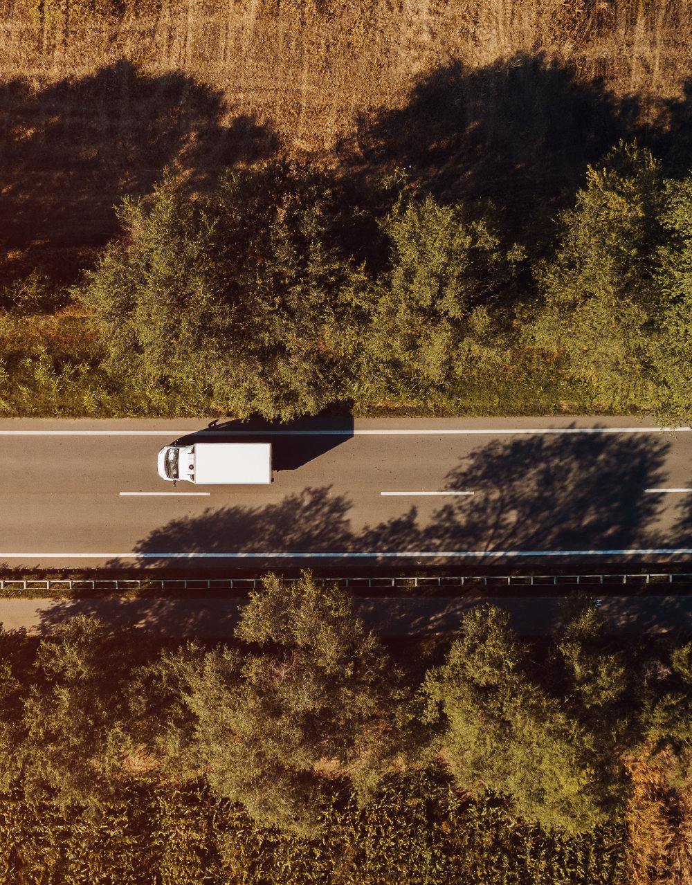 Top view of lorry truck on the road, aerial shot from drone pov